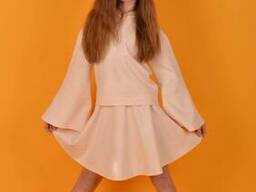 Модный трикотажный костюм с юбкой для девочки персикового цвета 146